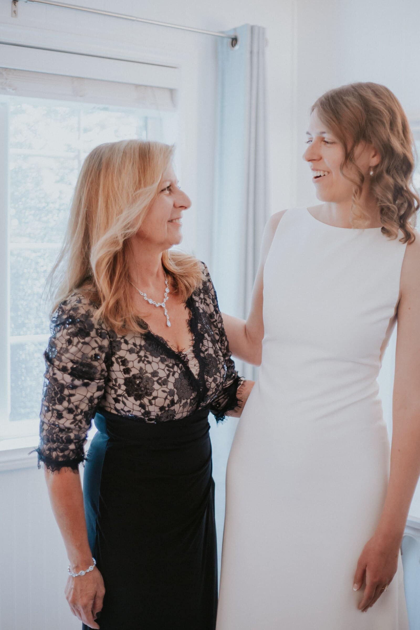 The bride with her mother, both smiling