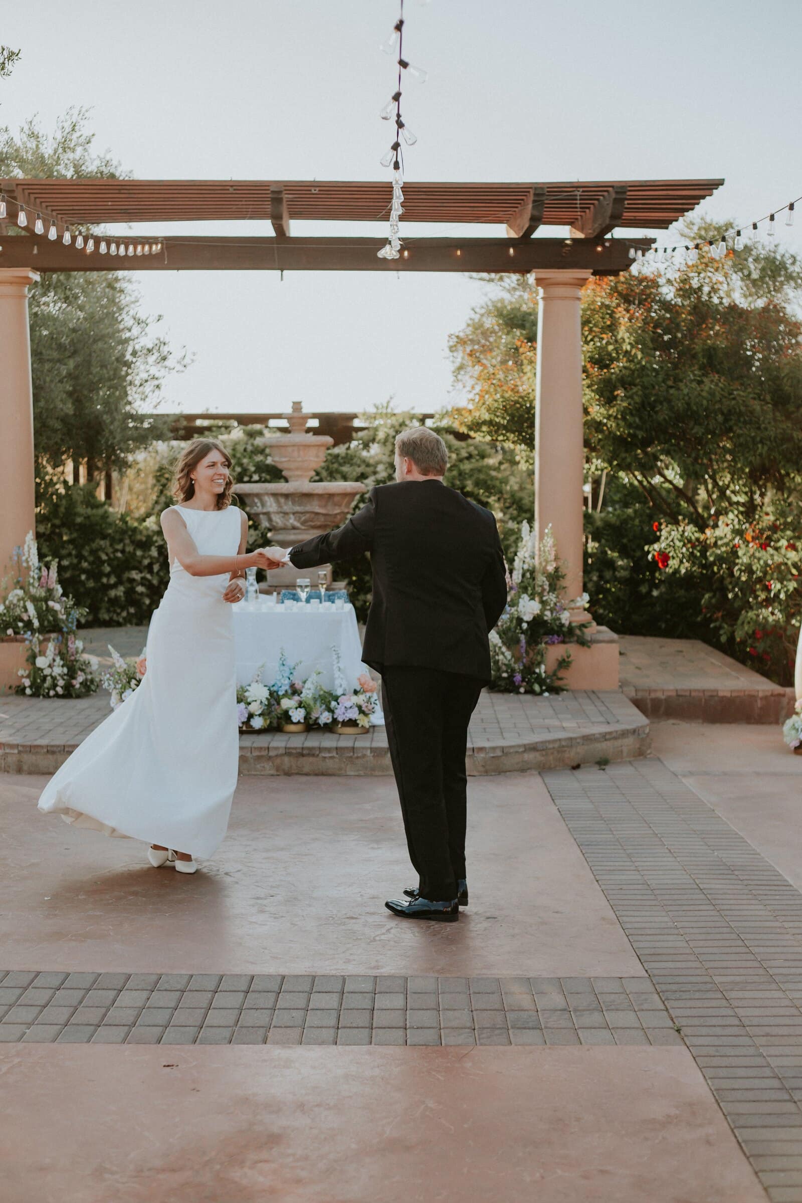 The bride sharing a dance on the patio under the pergola