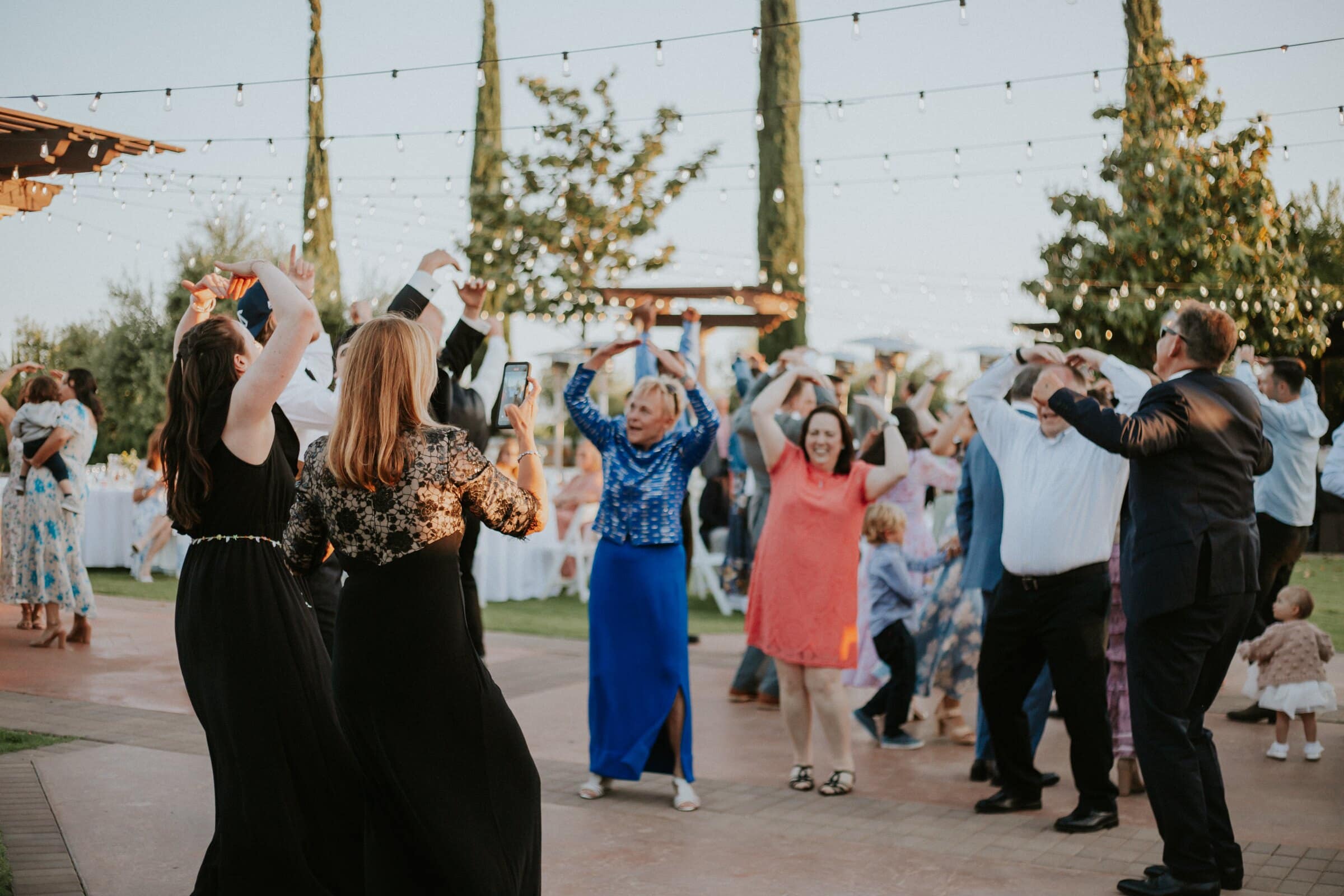 Guests dancing under string lights