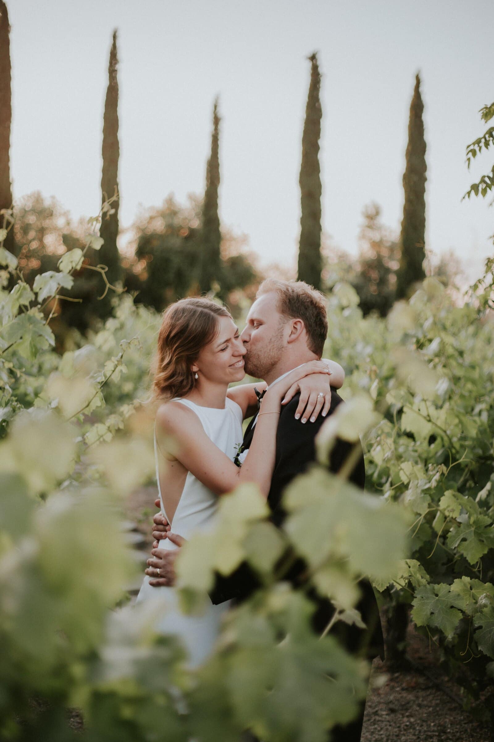 Blake and Ava laughing among the vines at golden hour