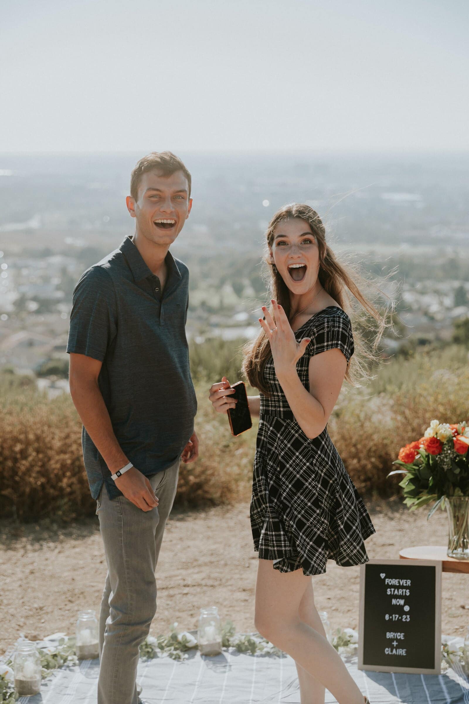 Claire beaming in surprise beside Bryce