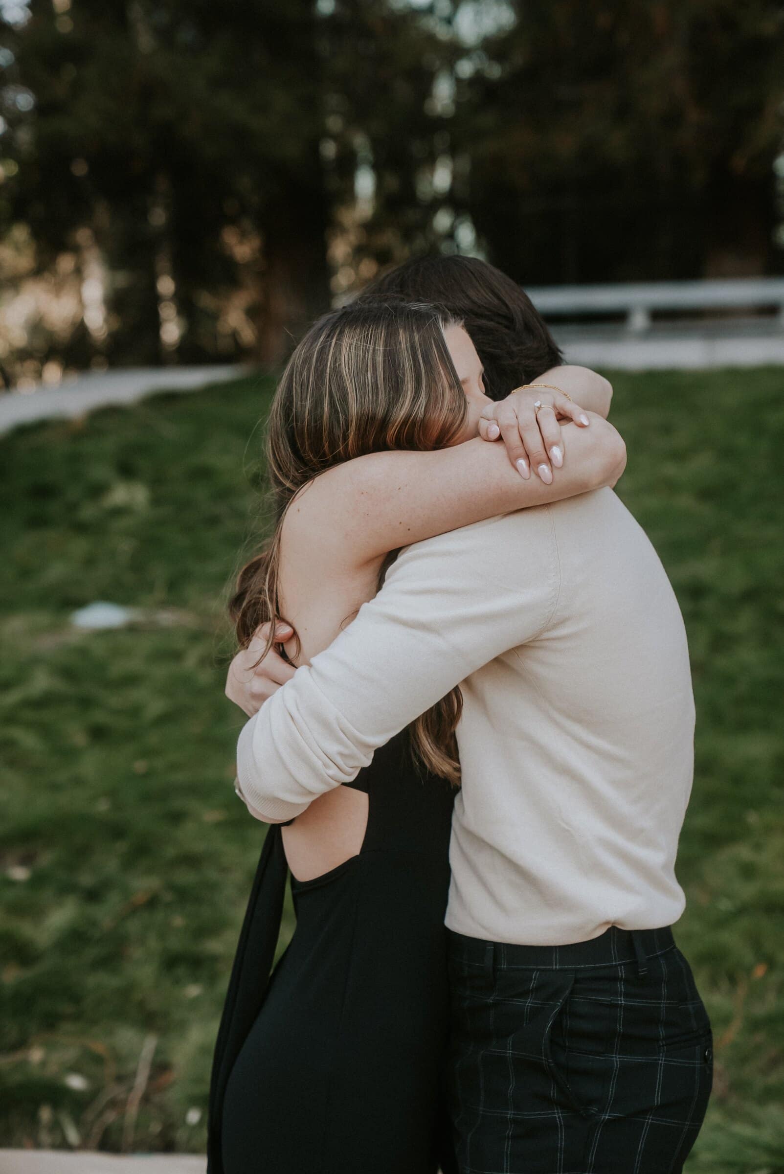 Cameron and Amanda holding each other tightly on the lawn