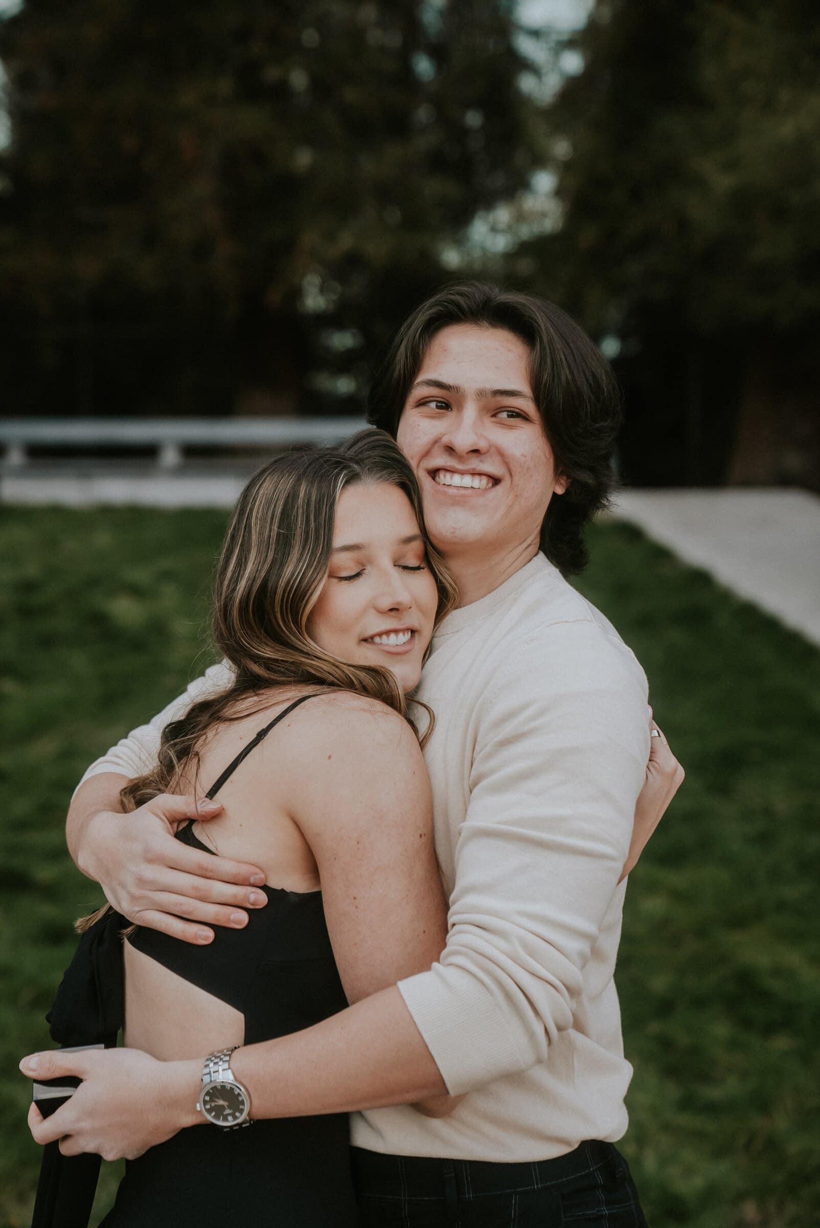 Cameron and Amanda smiling, wrapped in each other's arms