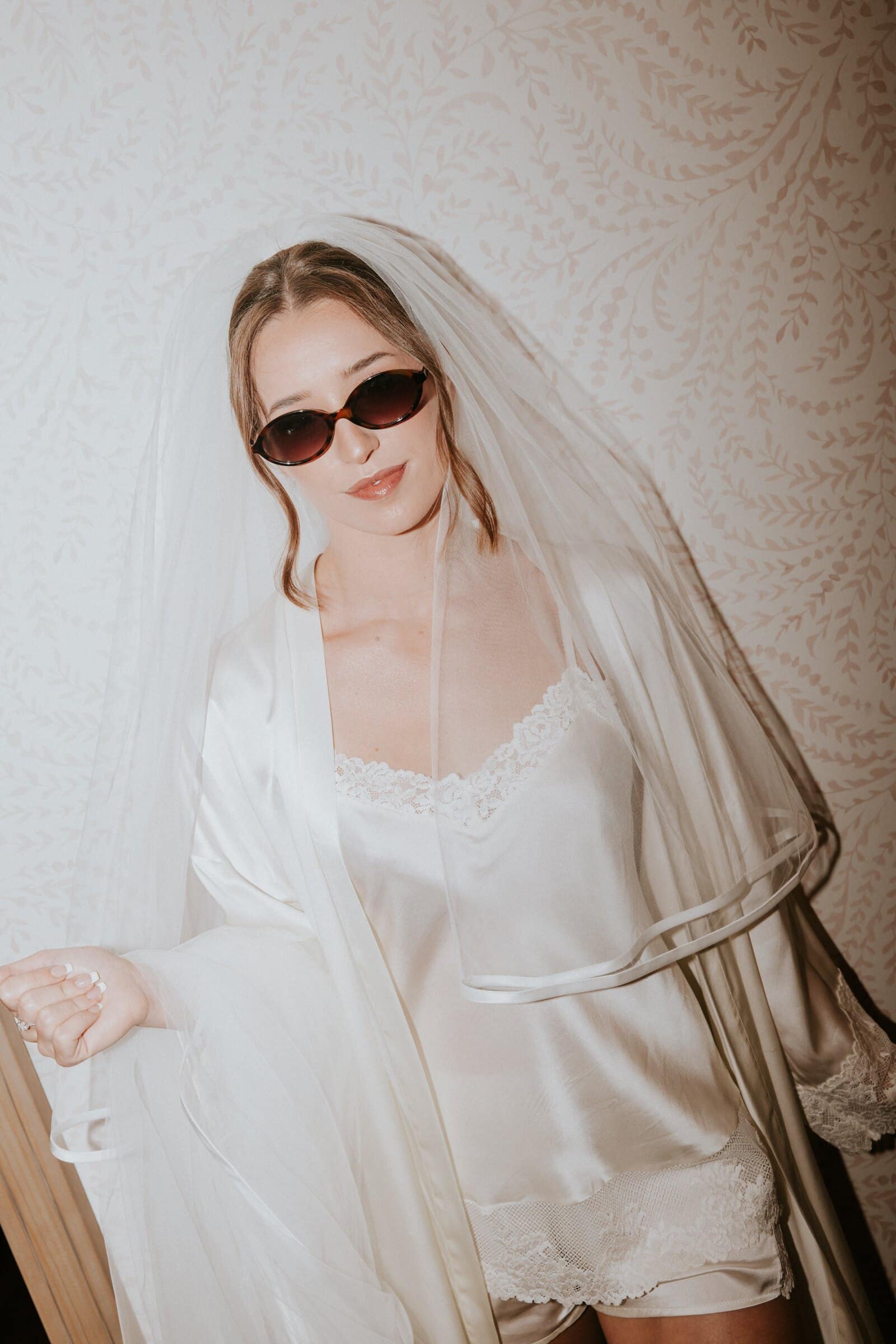 Clara in sunglasses and her veil while getting ready