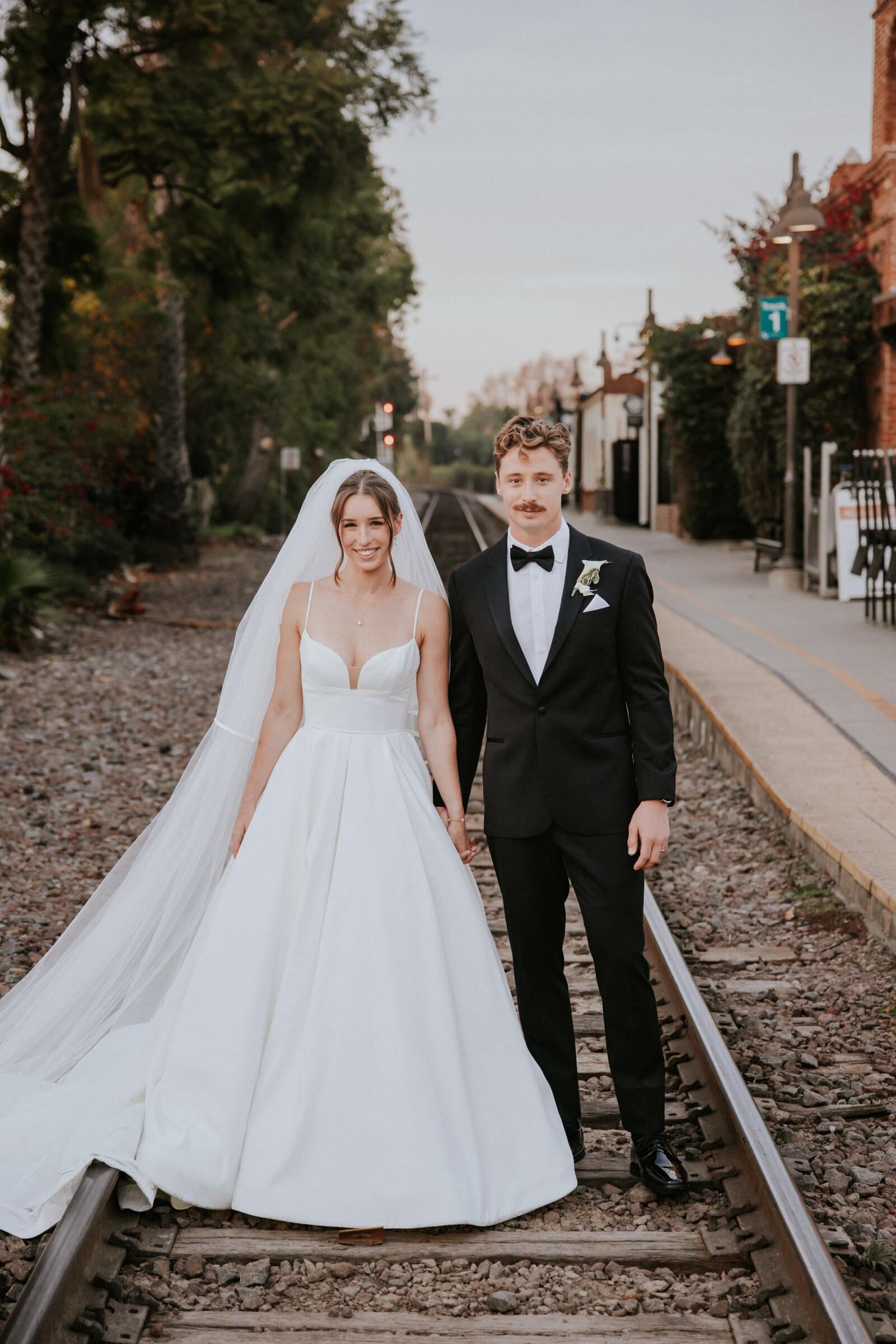 Clara and Grant standing on a railroad track