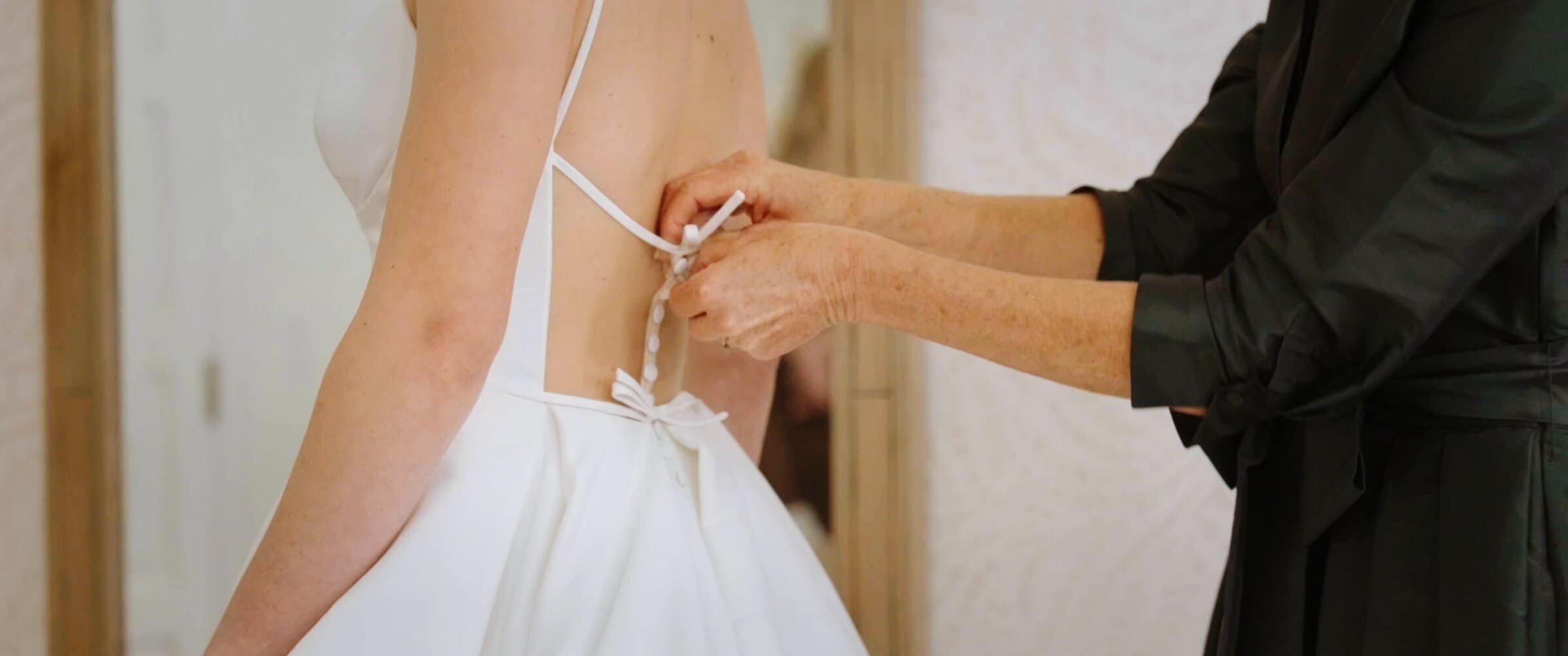 Clara's dress being laced up at the back