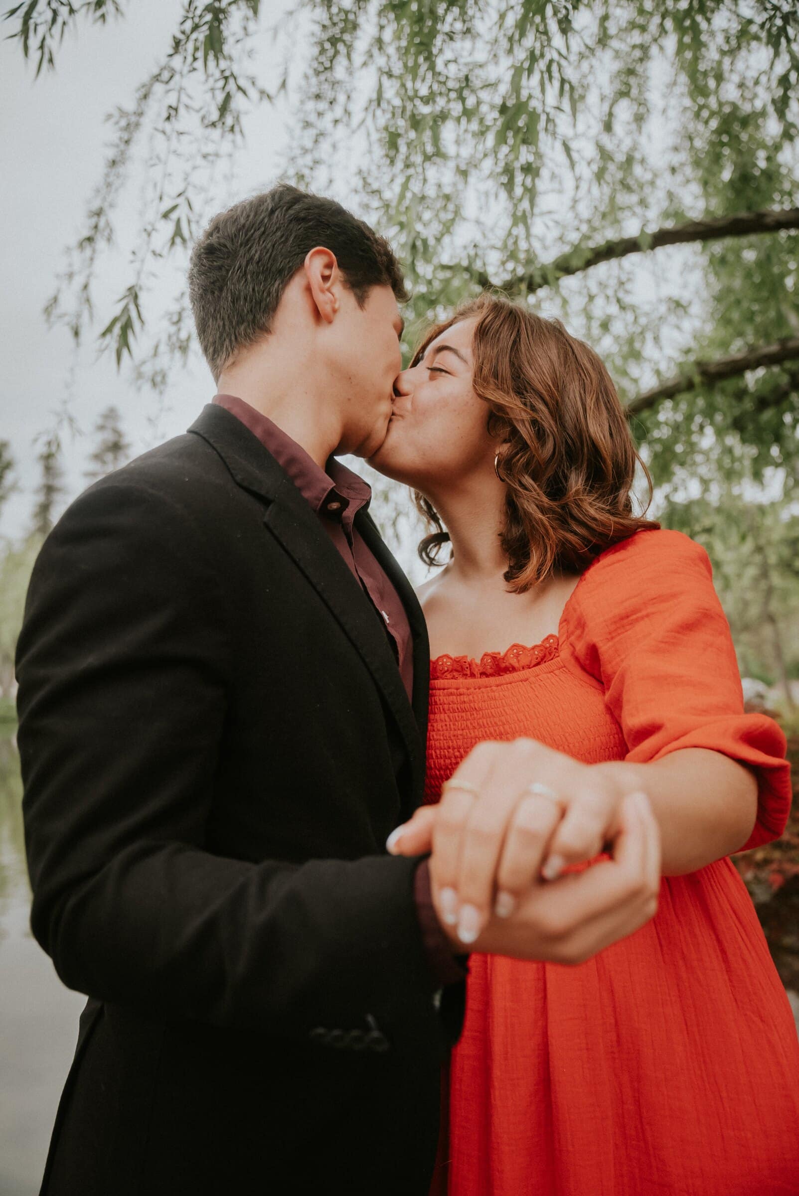 David kissing Natalie as she holds out her ring