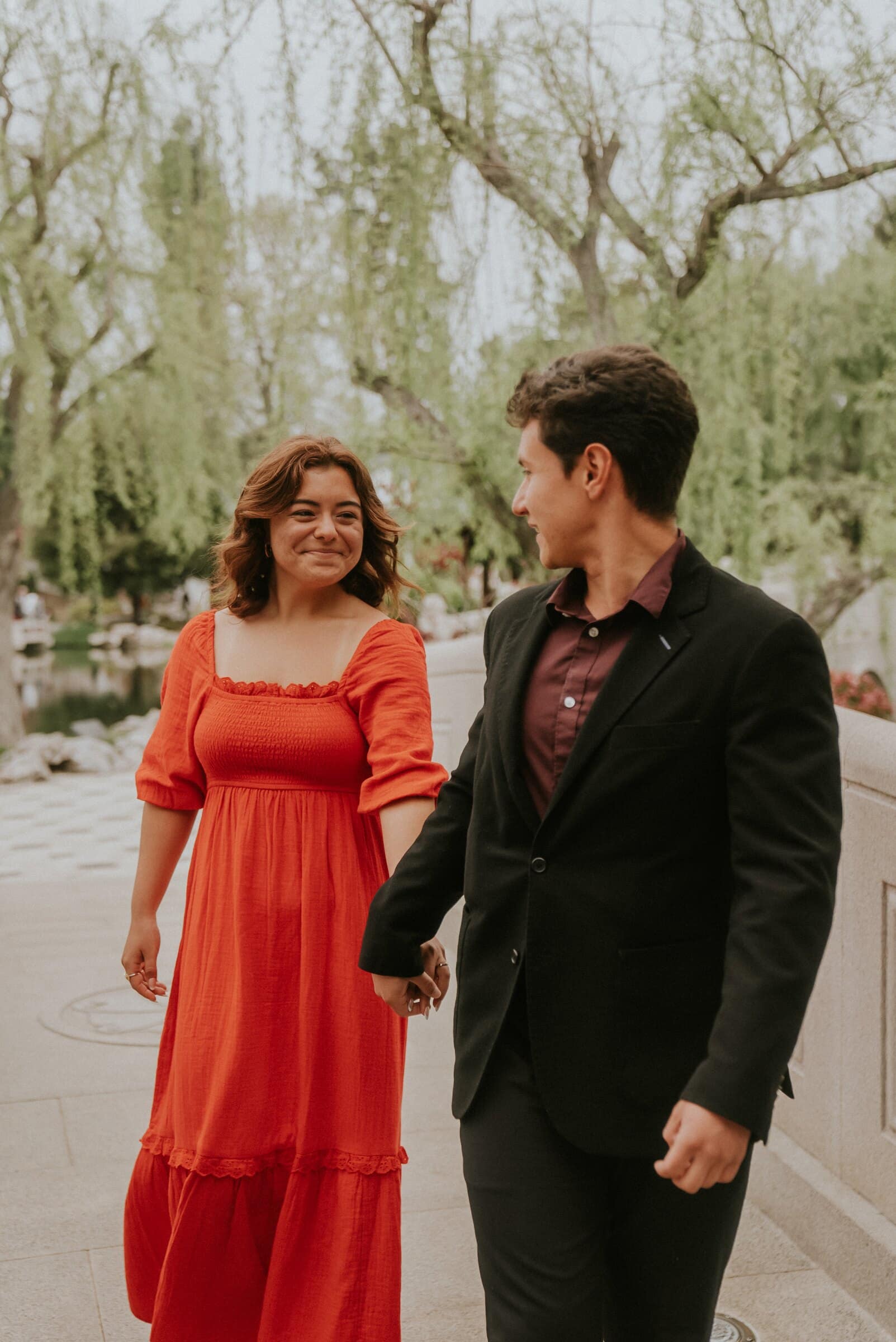 David and Natalie walking hand in hand across the bridge