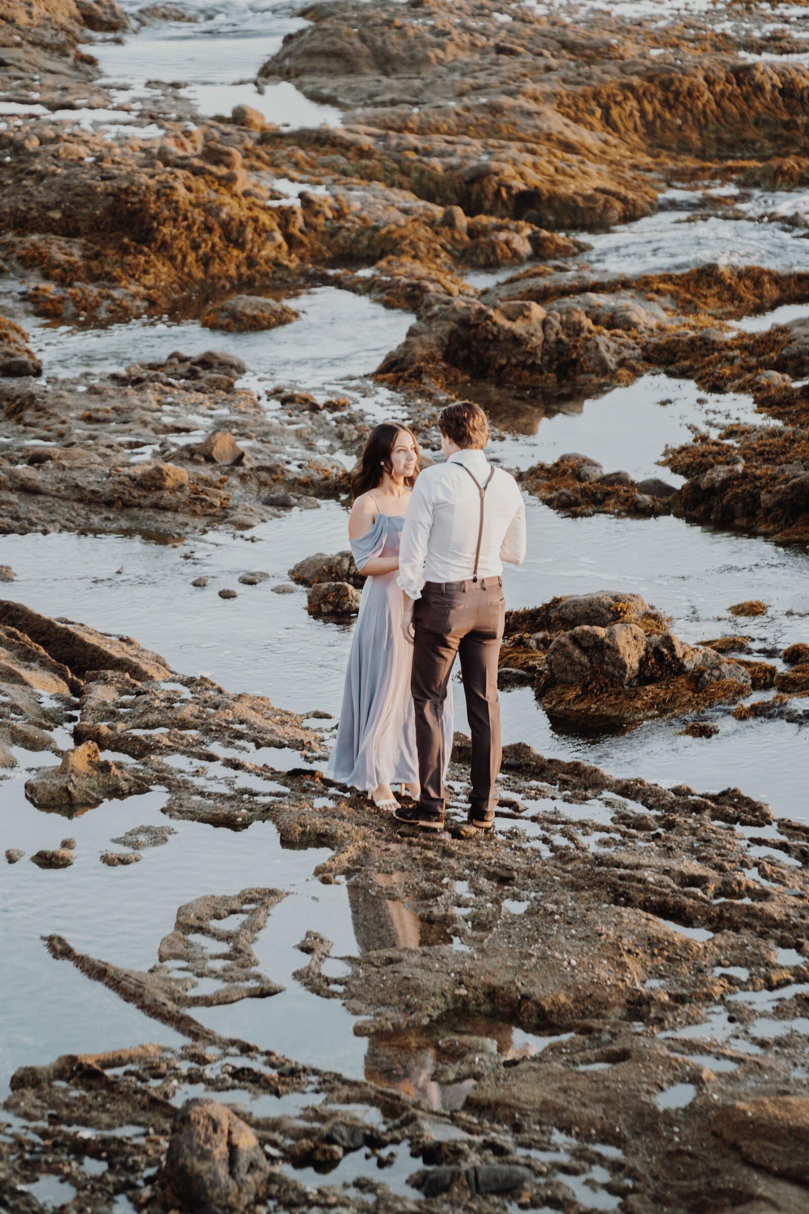 Dylan and Jasmine standing among tide pools at low tide