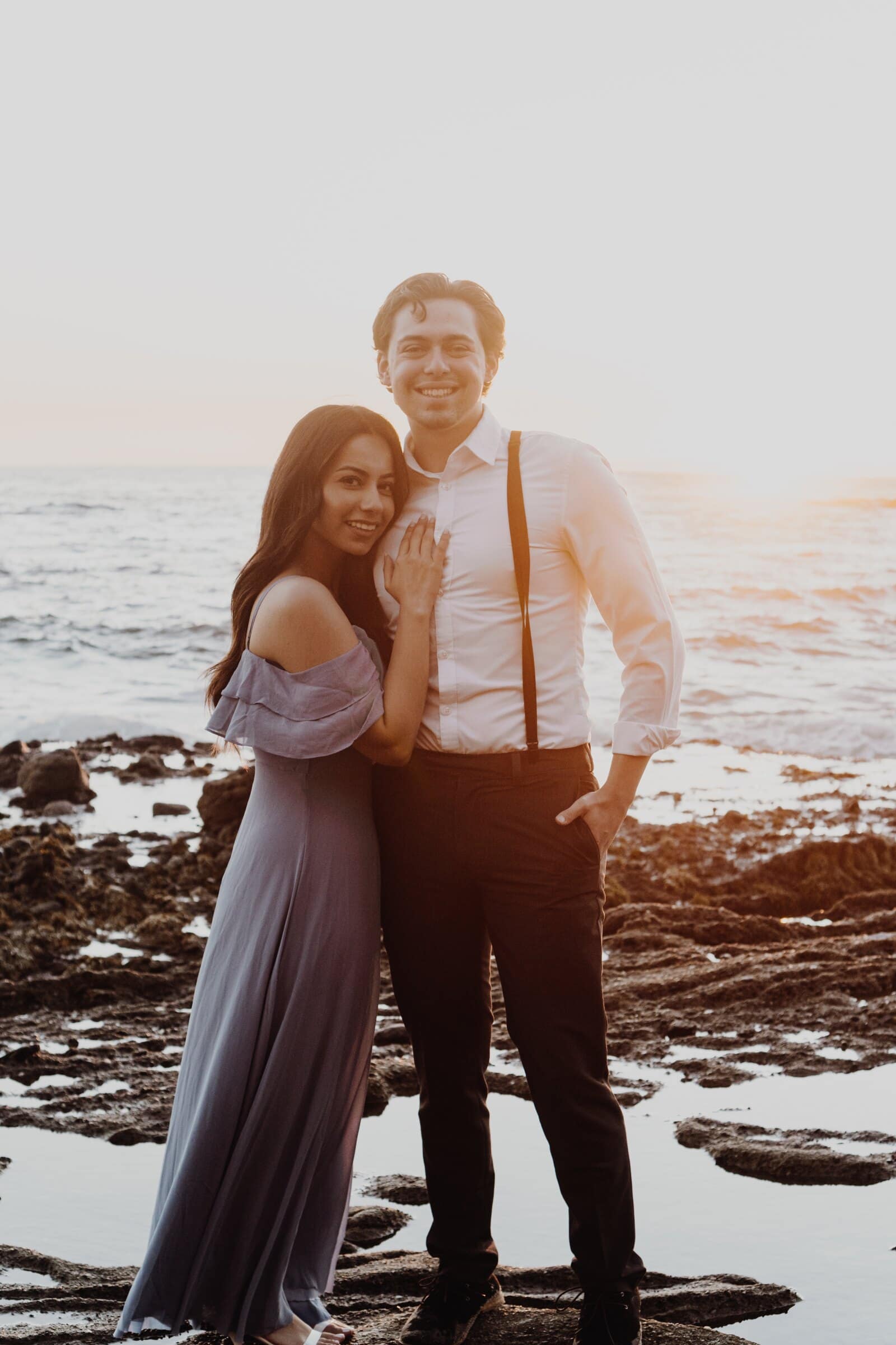 Dylan and Jasmine smiling in the low sun by the water
