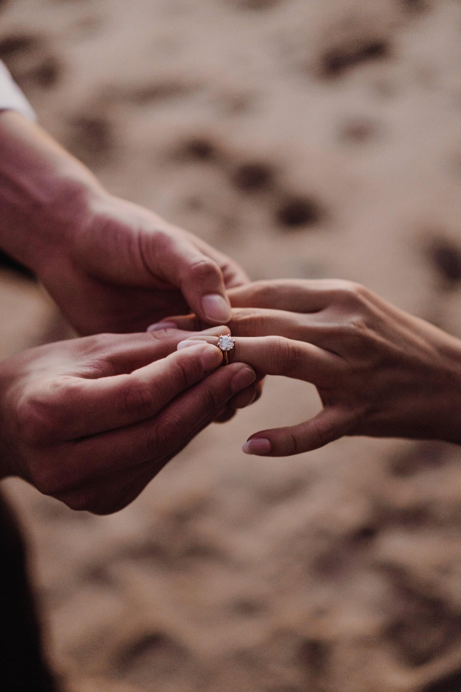 A close-up of the ring going onto Jasmine's finger