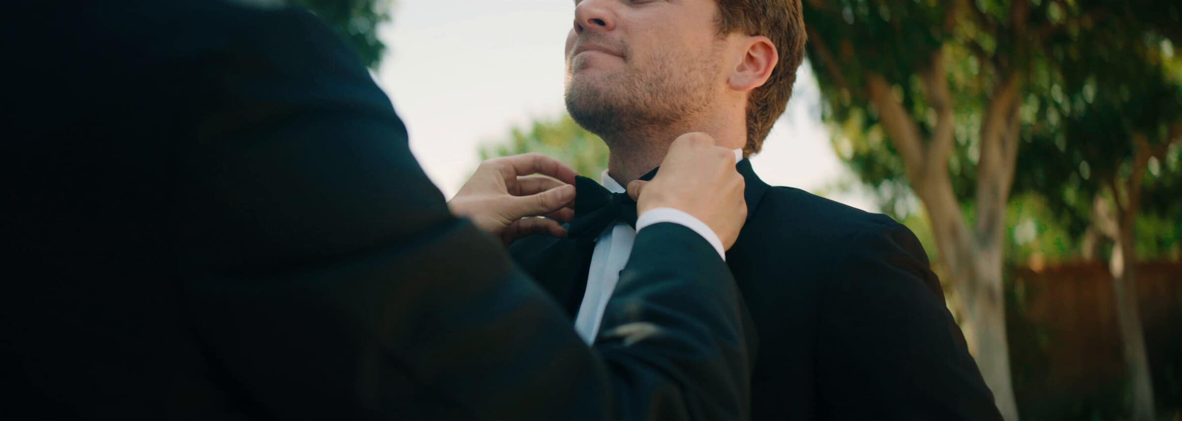 The groom having his bow tie straightened