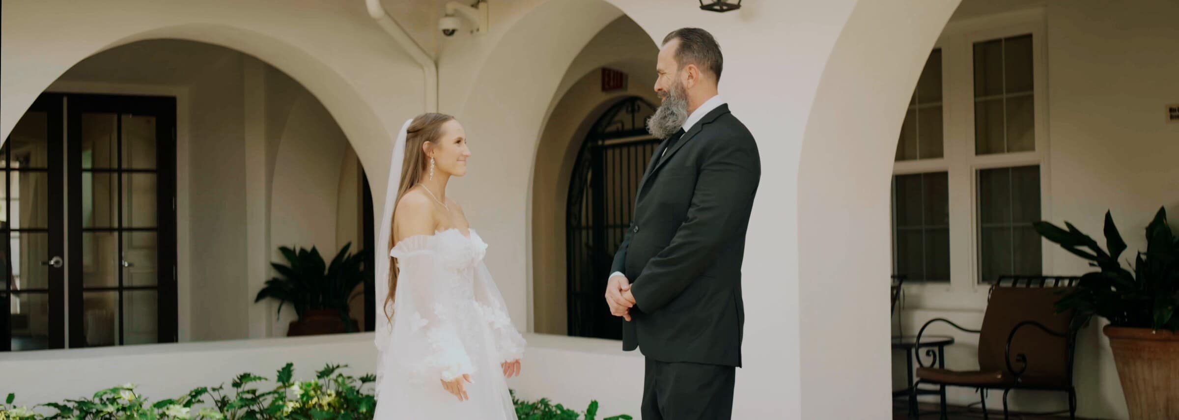 A first look in a courtyard of white arches