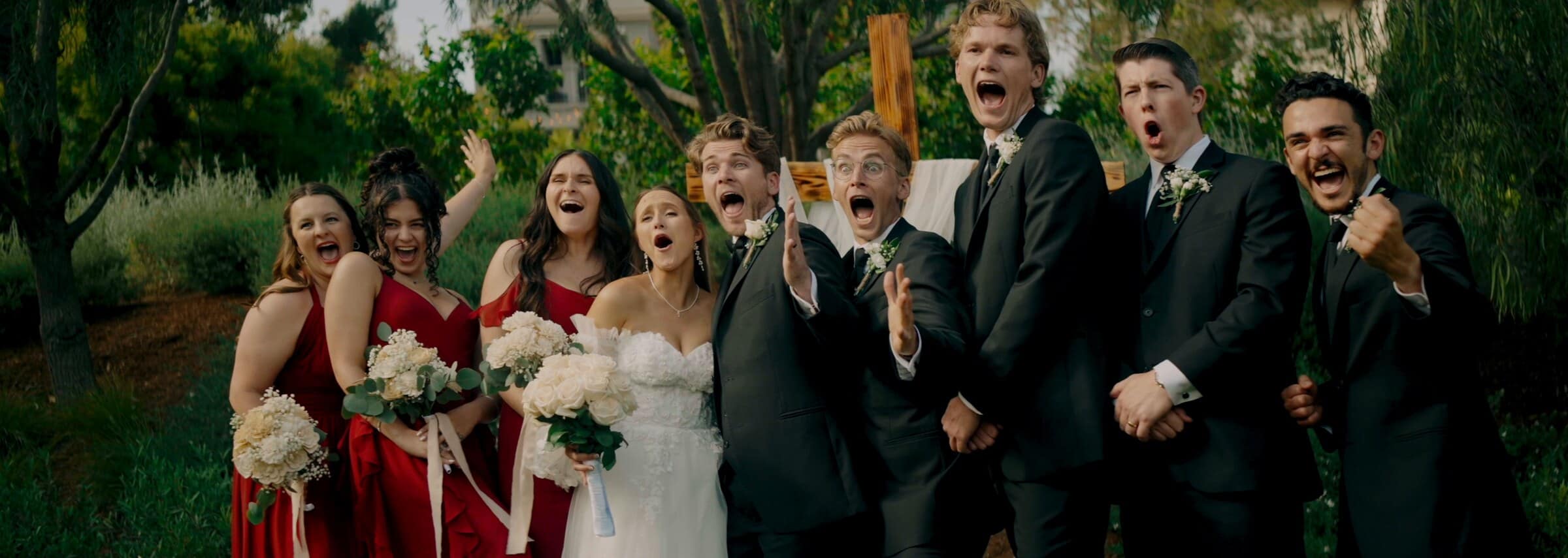 The wedding party cheering after the ceremony
