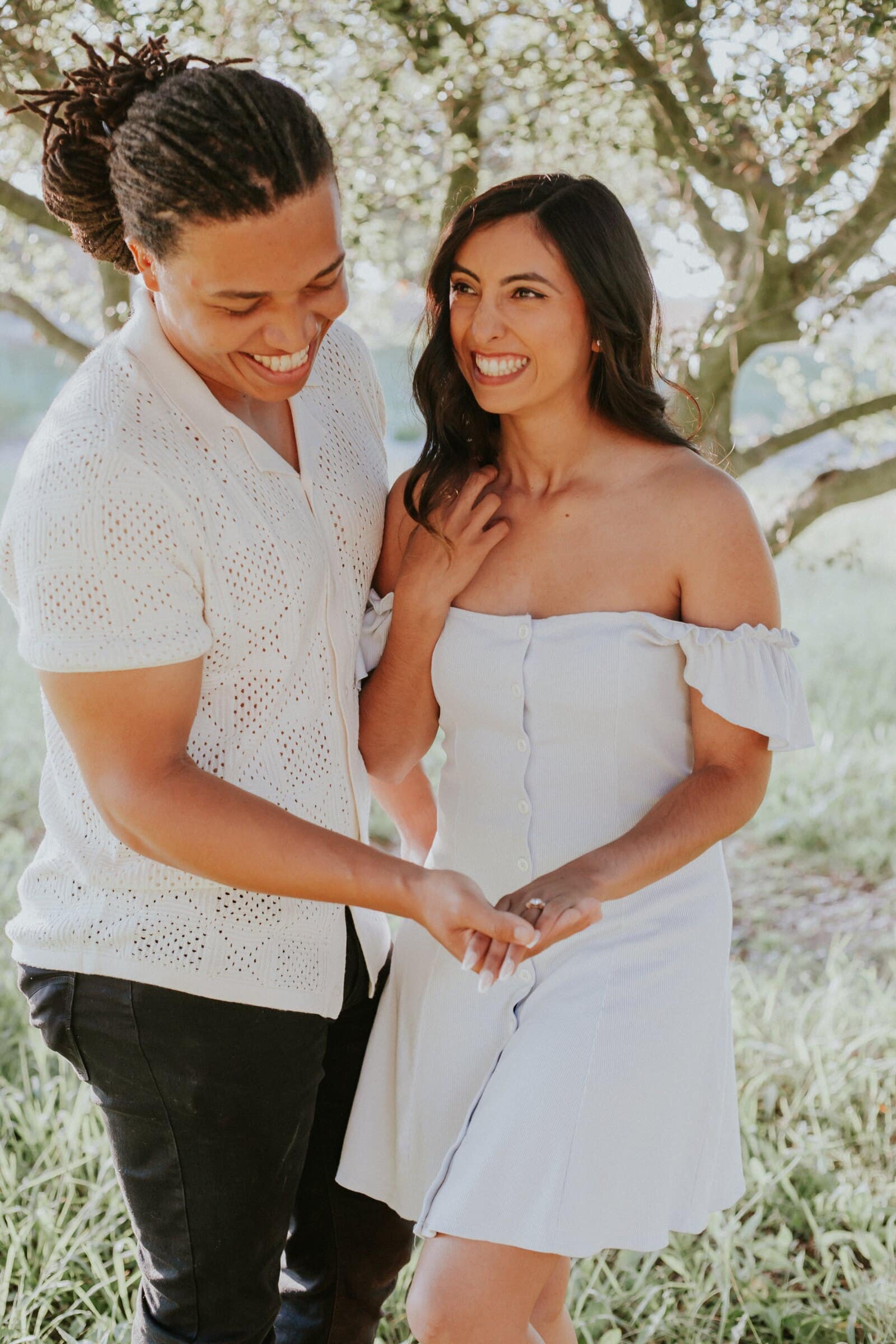 Jeremy and Ambica laughing together, holding hands