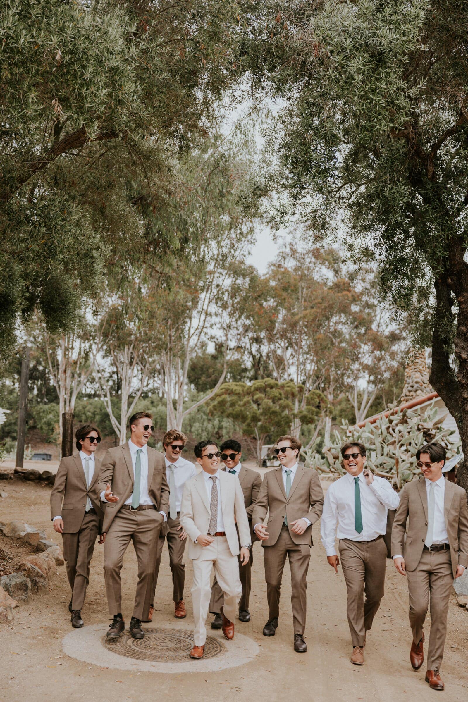 Caleb and his groomsmen walking together in sunglasses