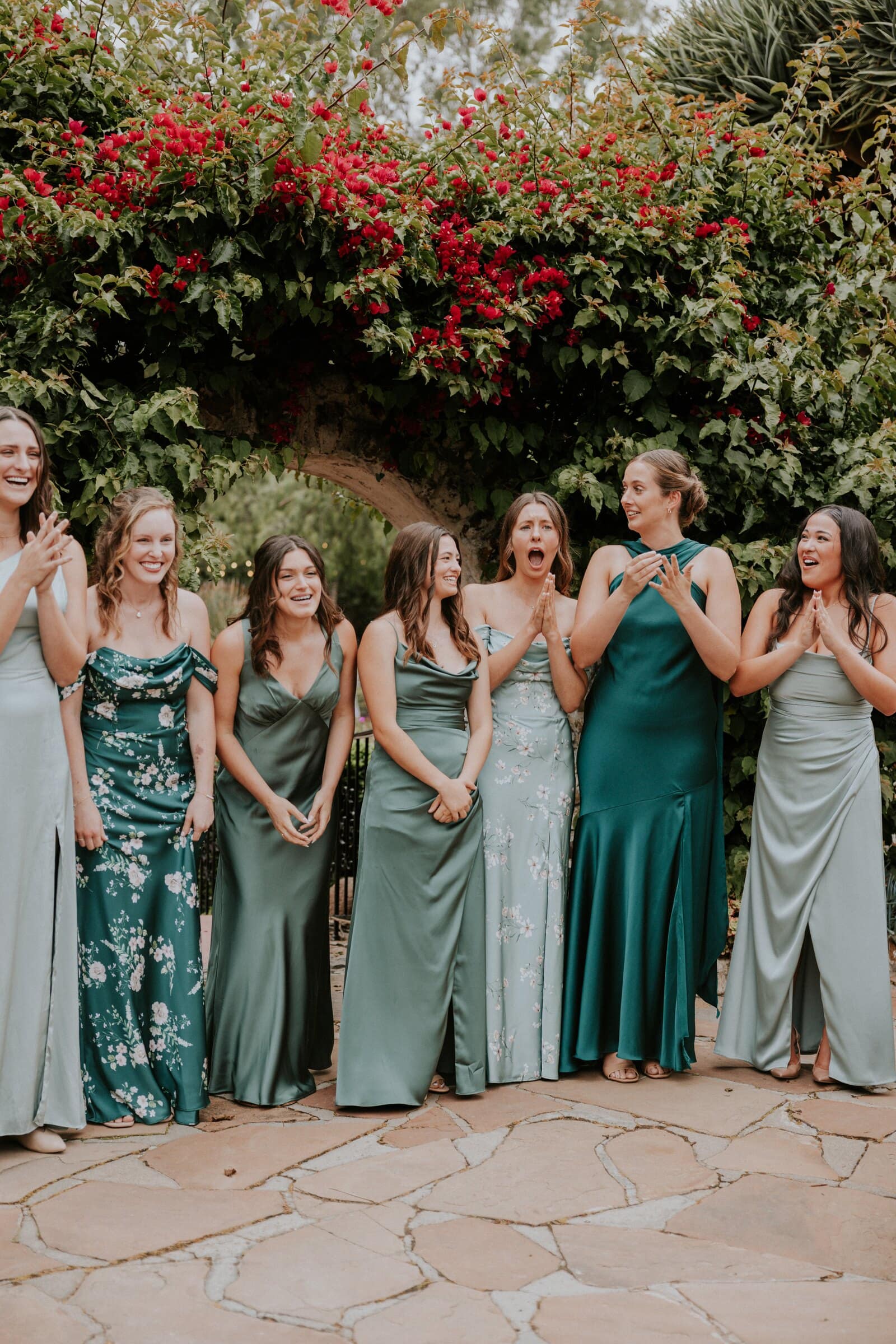 Megan's bridesmaids in green reacting as they see her