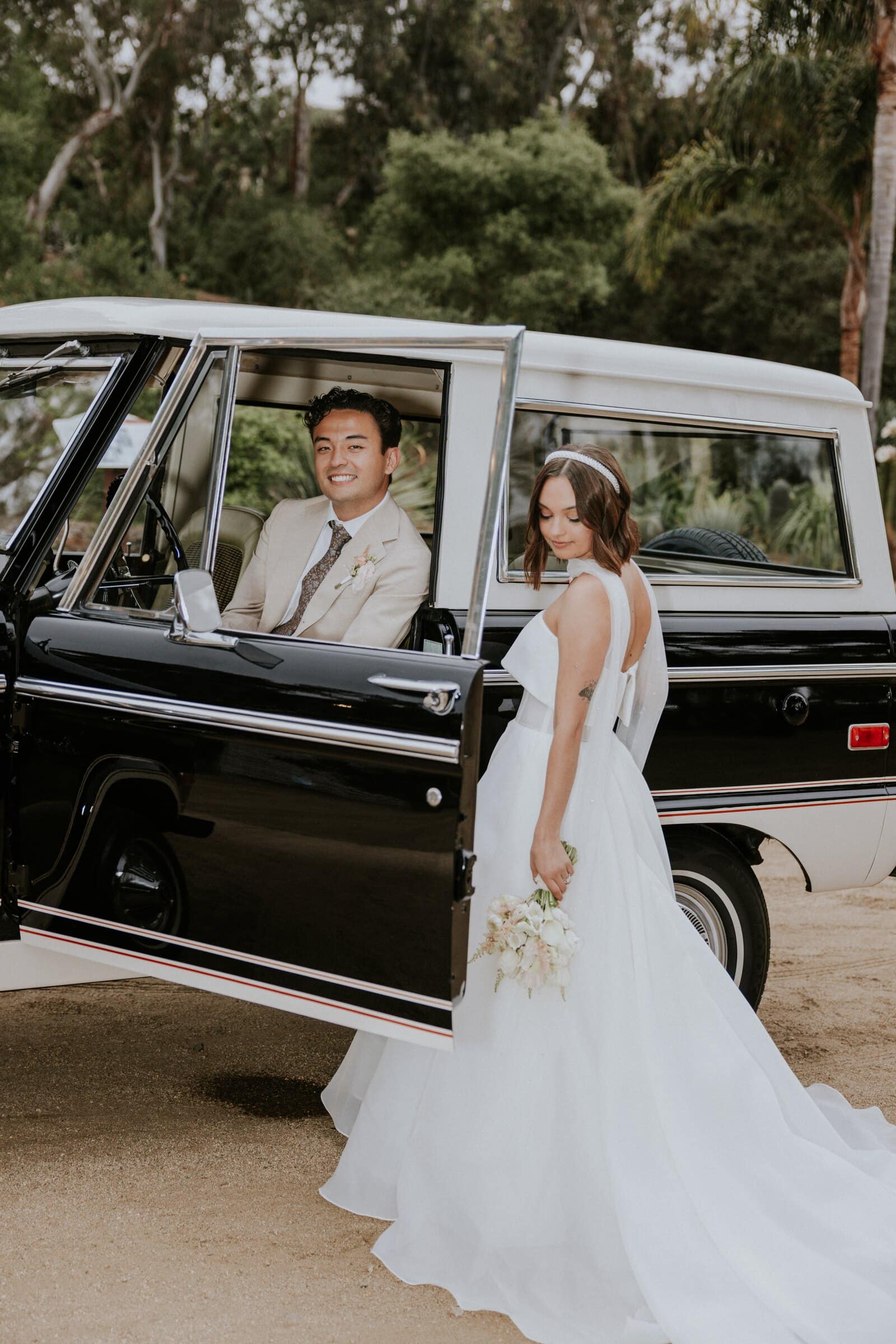 Megan stepping out of a vintage Ford Bronco