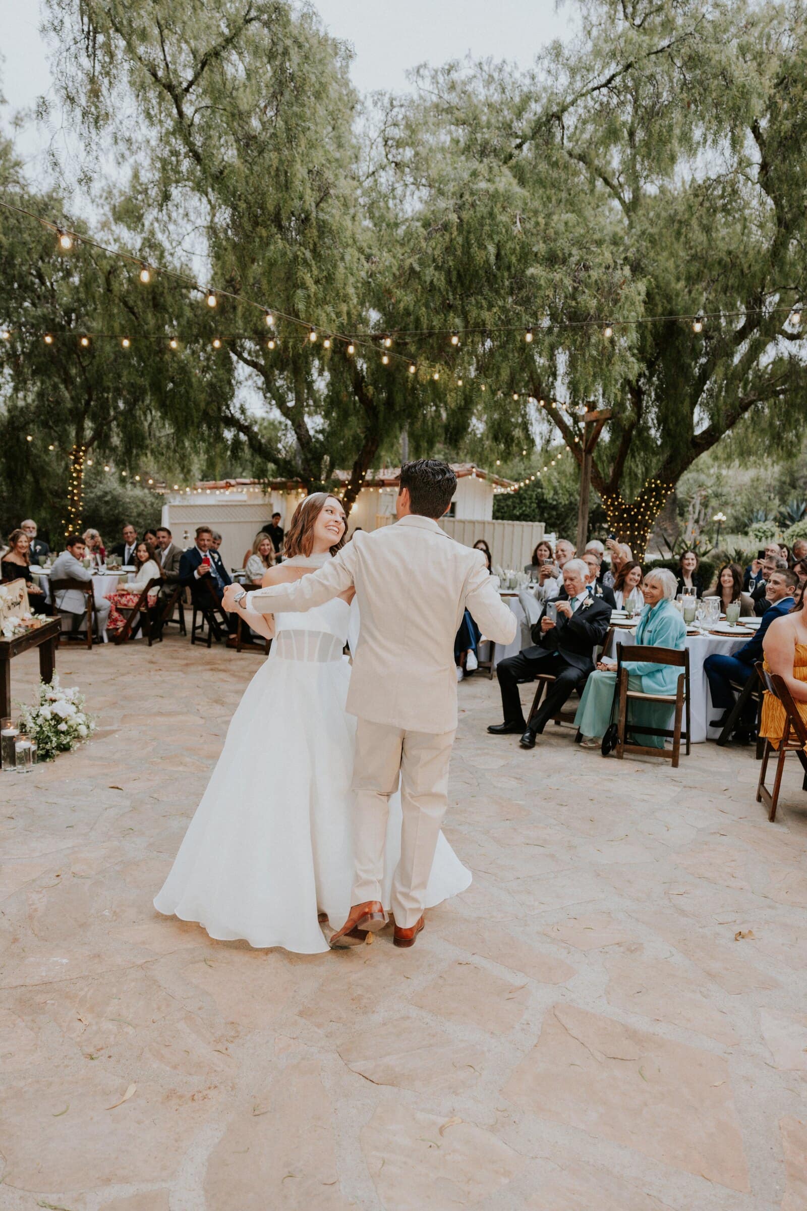 Megan and Caleb's first dance under string lights