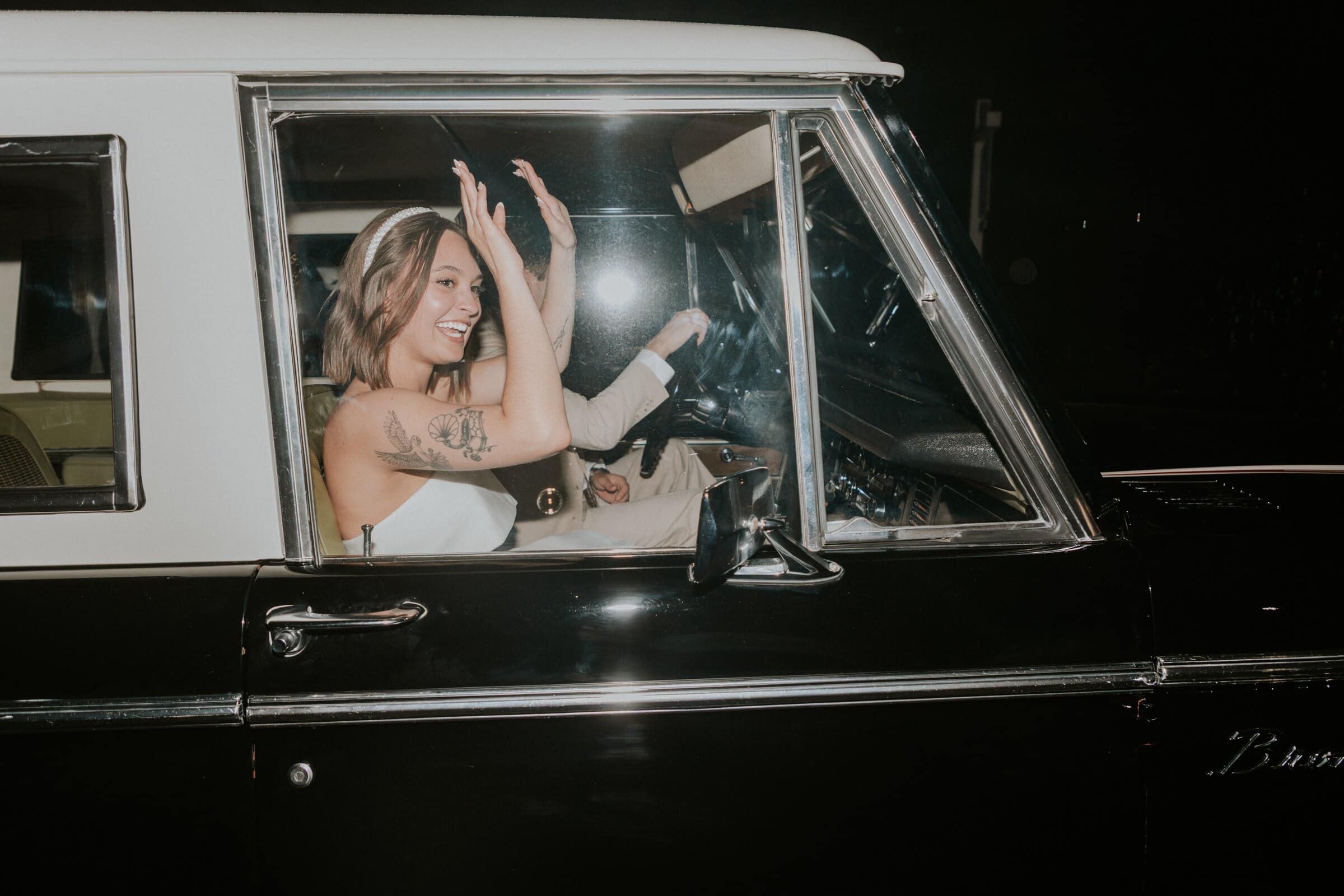 Megan waving from the Bronco as they leave