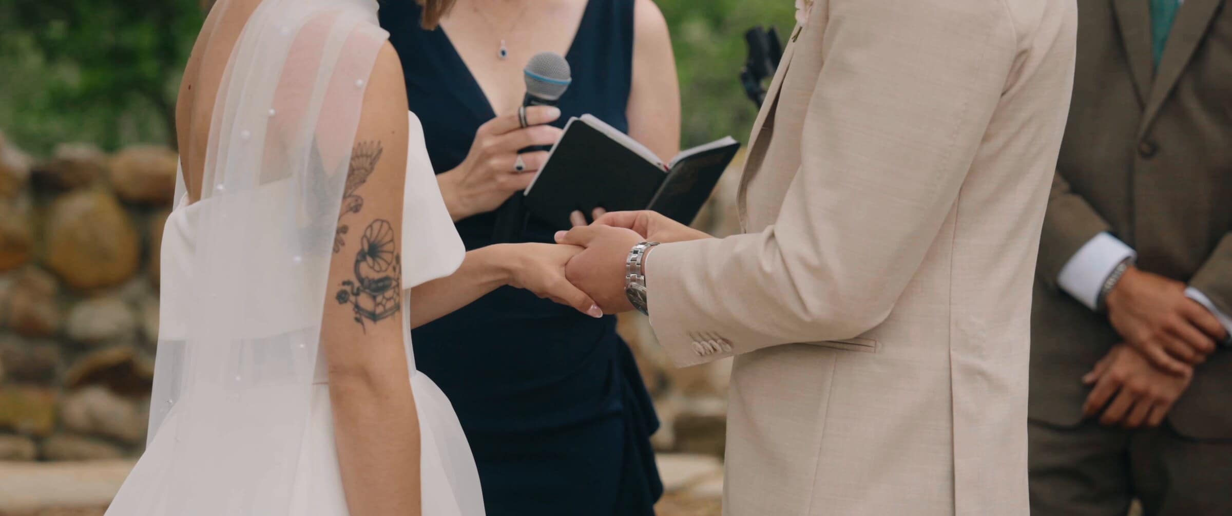 Megan and Caleb holding hands during their vows