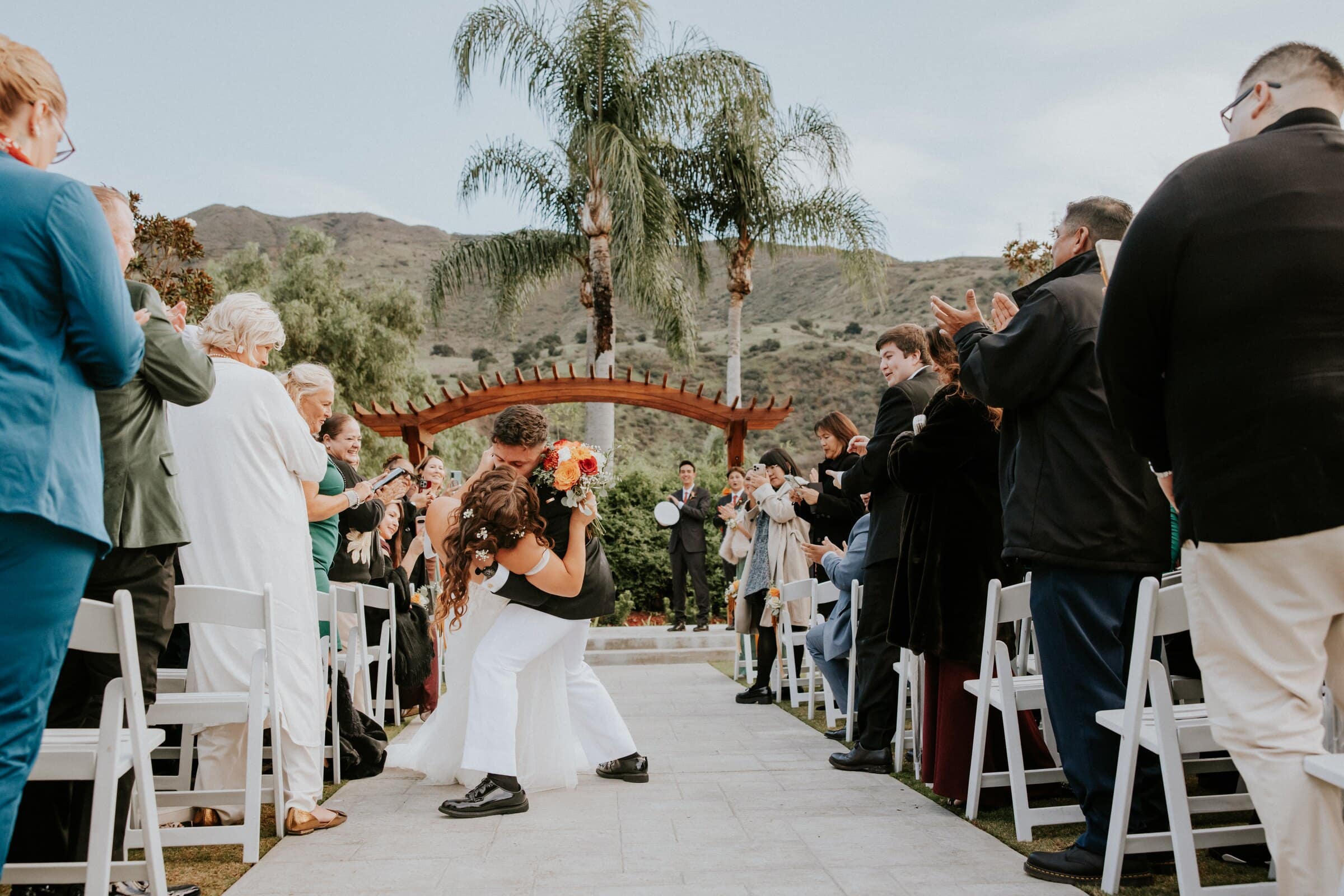 Natalie walking down the aisle between the guests