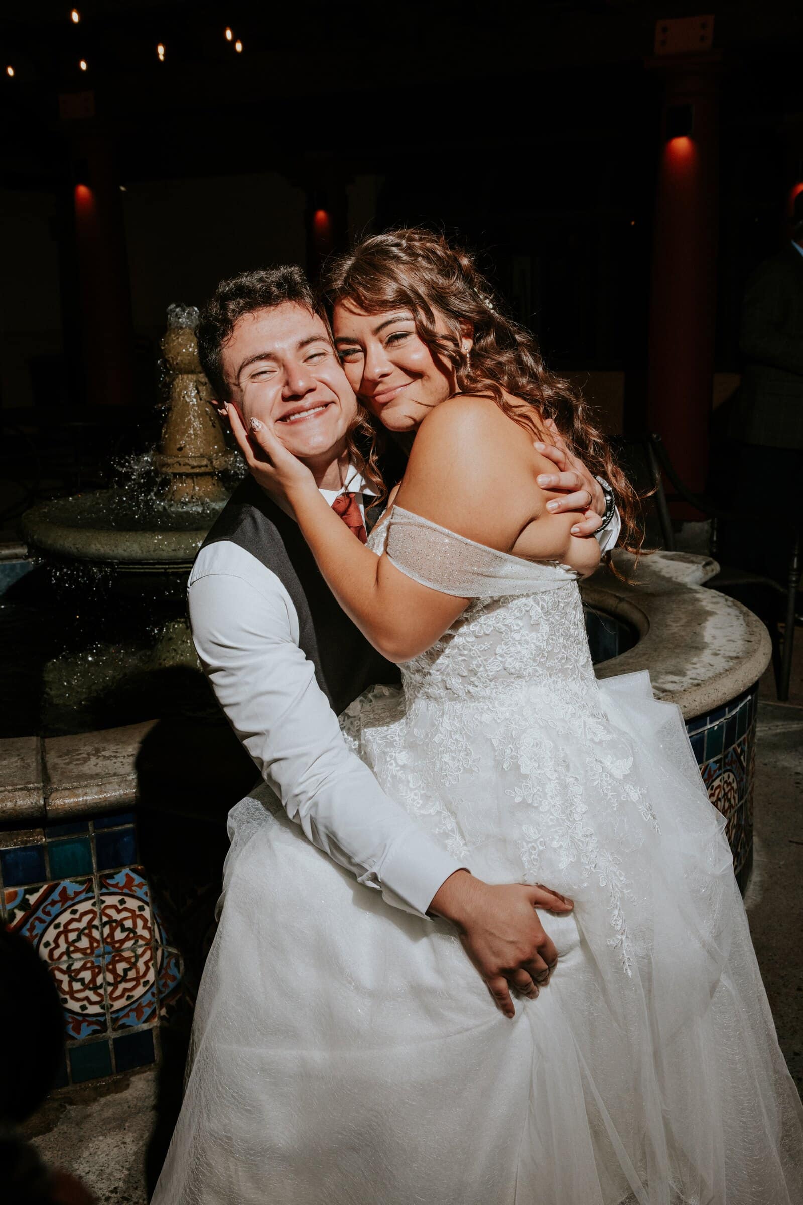Natalie and David hugging on the dance floor at night