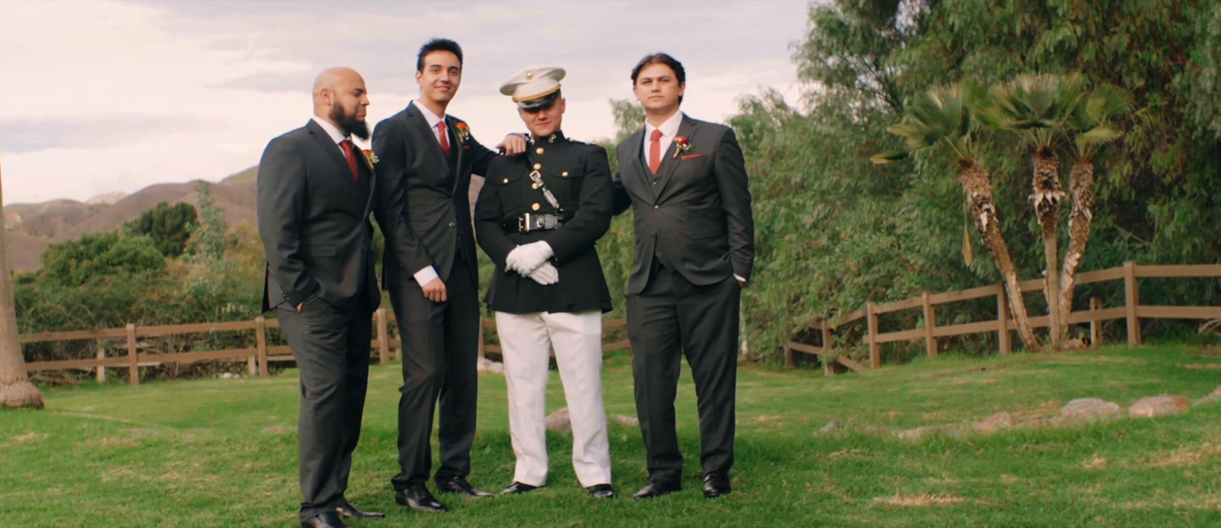 The groomsmen on a lawn, one in Marine Corps dress blues