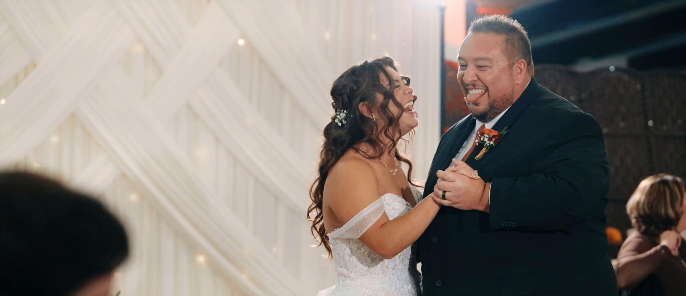 Natalie laughing during a dance with family