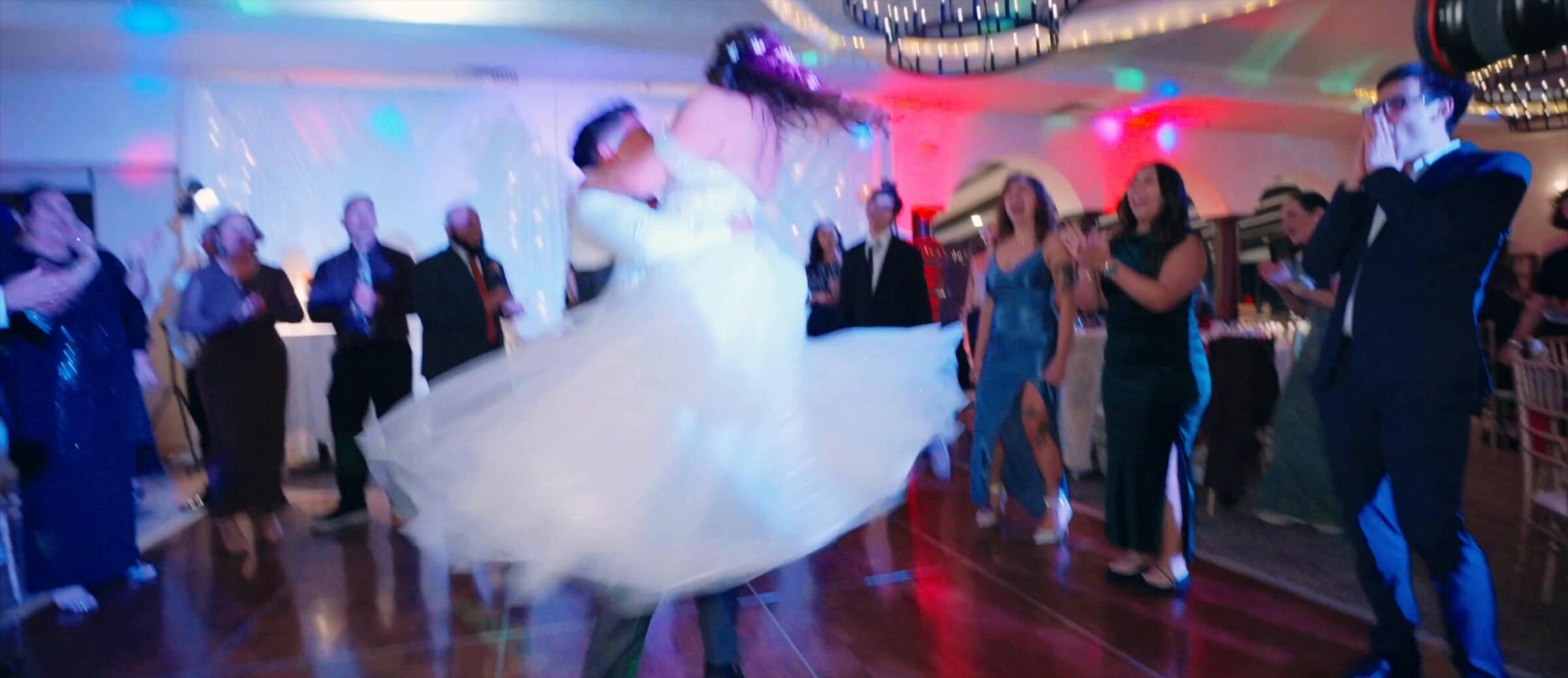 Natalie twirling on the dance floor under coloured lights
