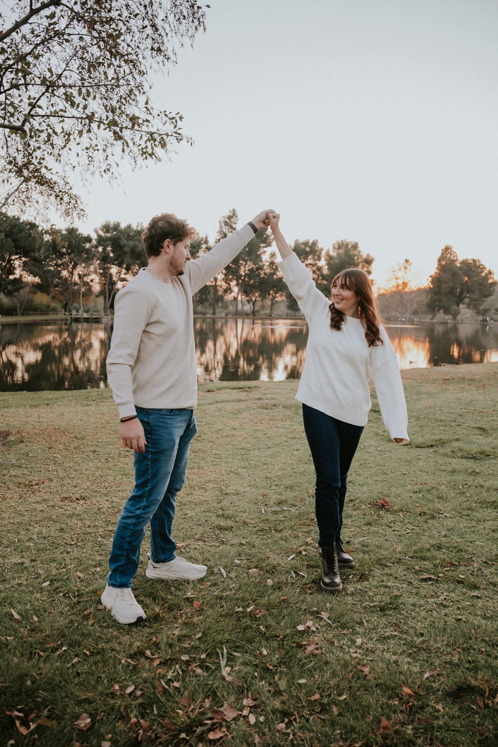 Nick and Ren dancing on the lawn, arms raised in a twirl