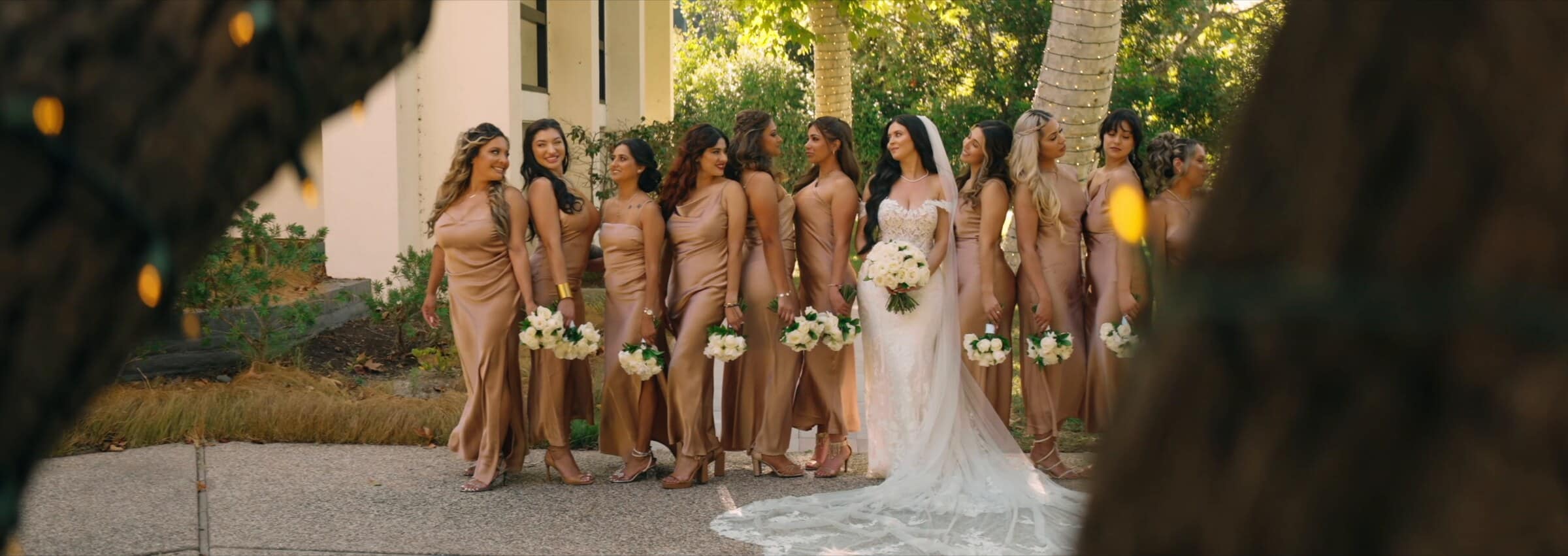 The bride with her bridesmaids in champagne-coloured dresses