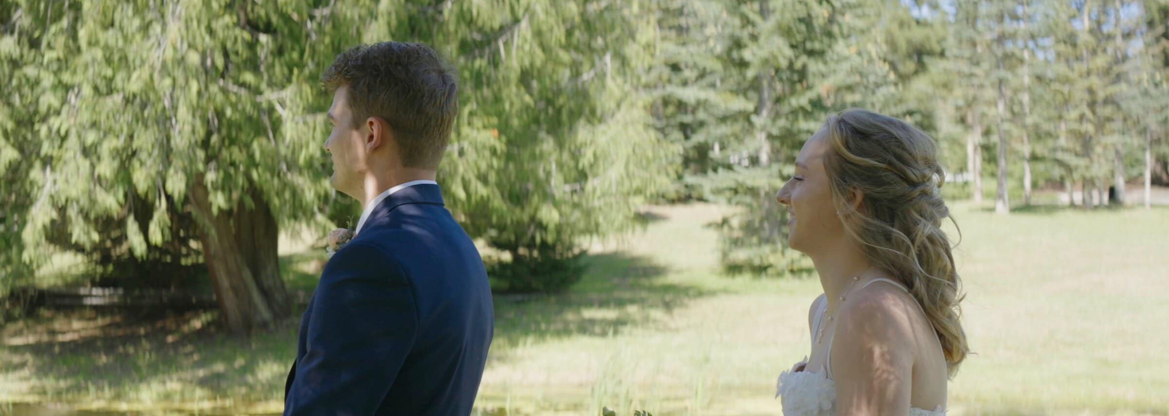 Sarah and Trent's first look in a sunny meadow