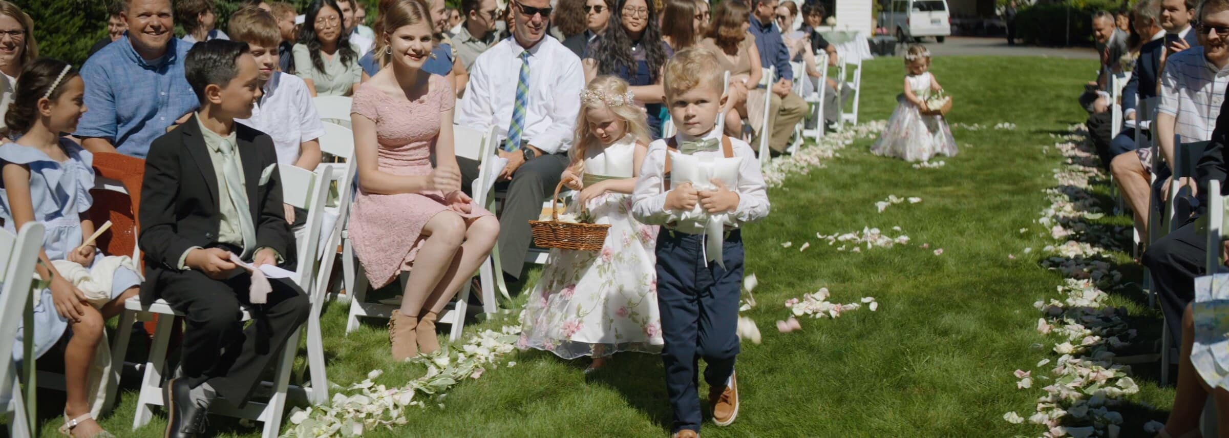 The flower girl and ring bearer walking down the aisle