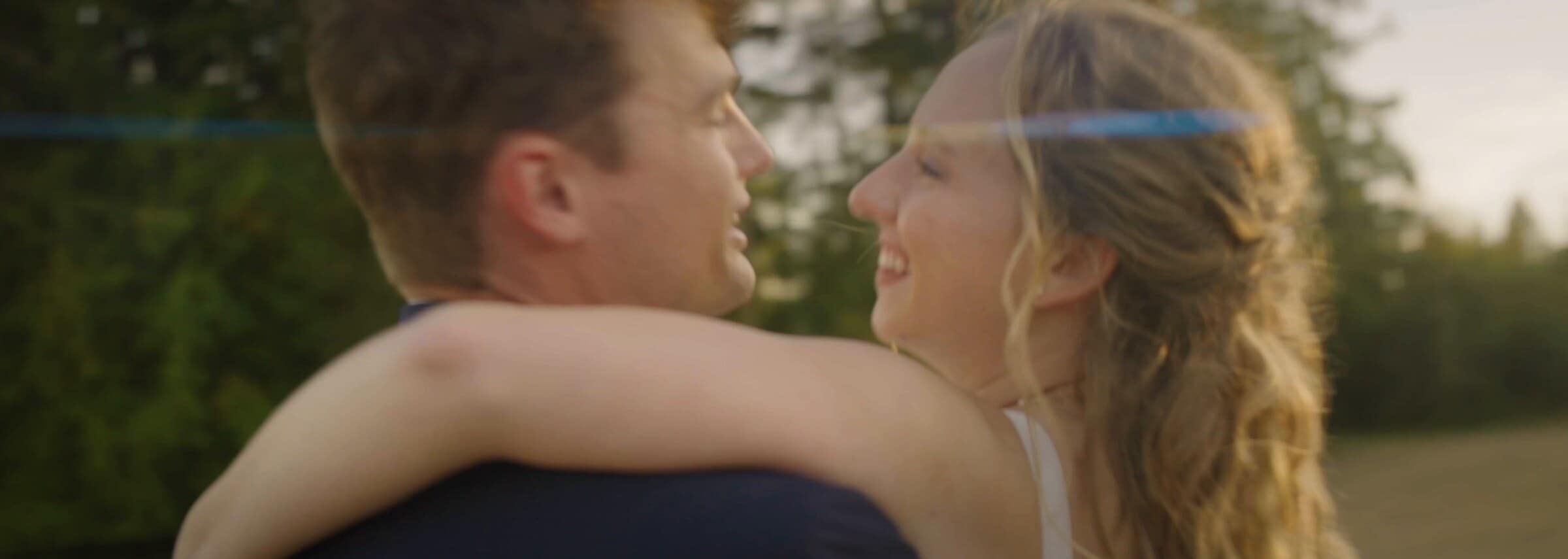 Sarah and Trent embracing in the evening sun