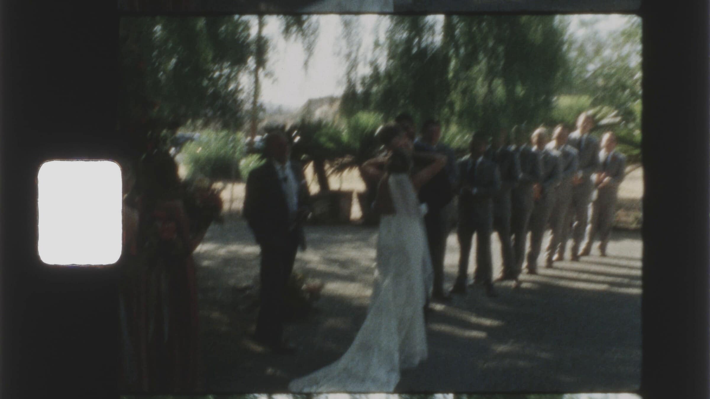 The bride walking down the aisle toward the groom and his groomsmen