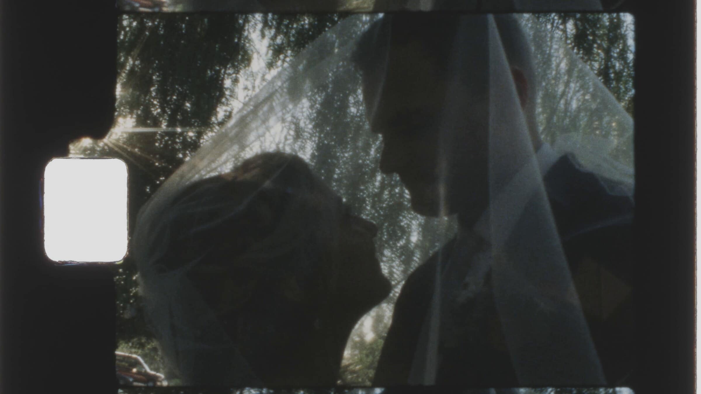 Tucker and Bailey close together under her veil