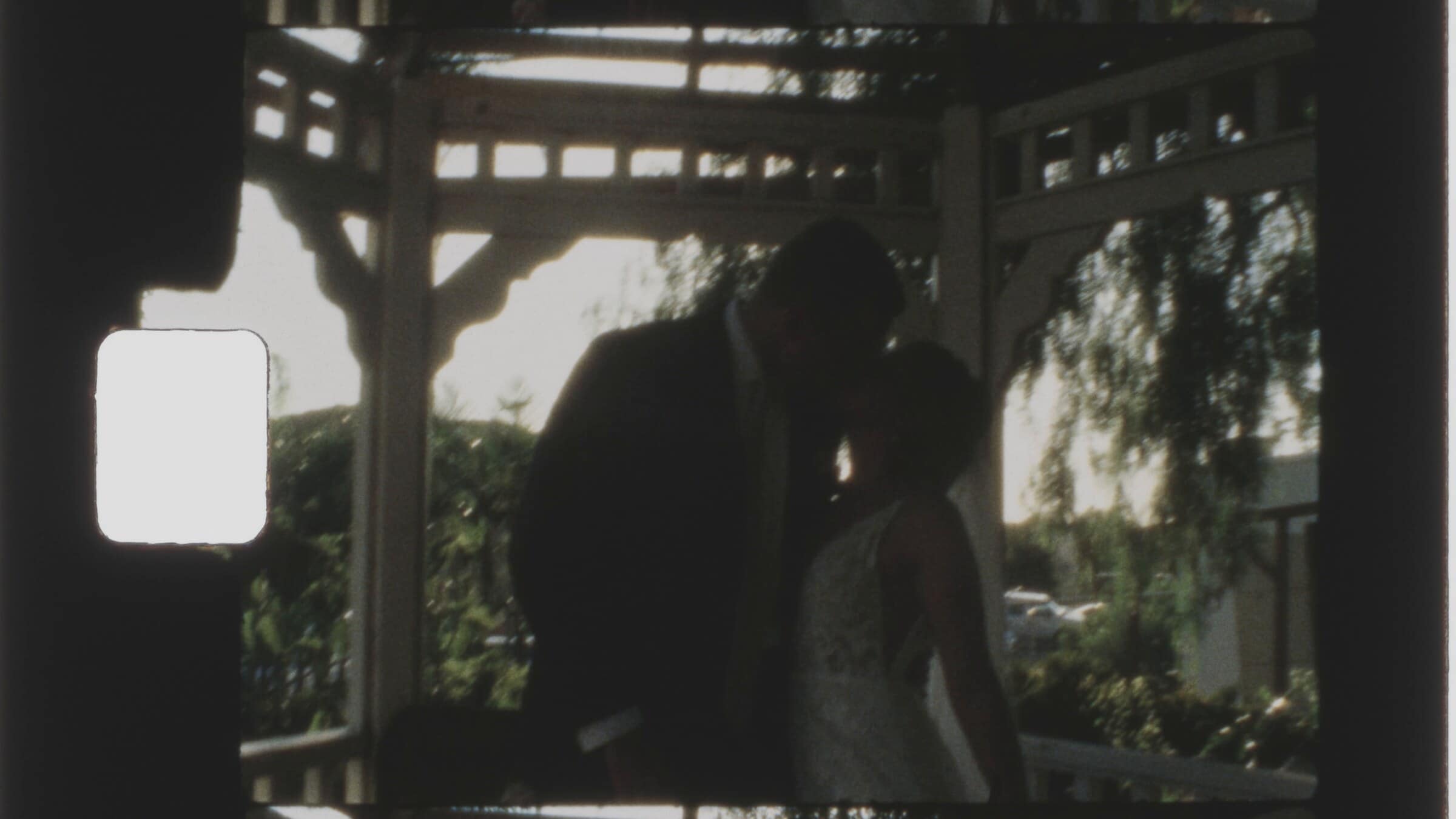 Tucker and Bailey kissing in a white gazebo